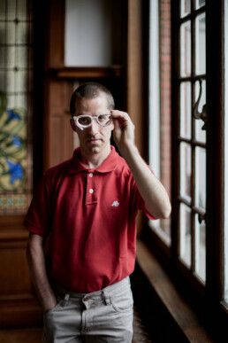 ceramic artist standing by a window holding ceramic glasses